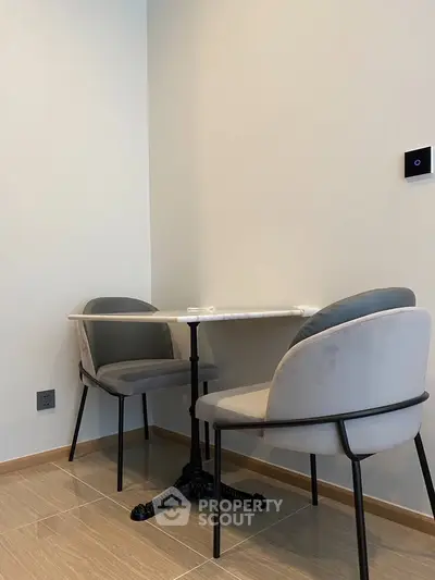 Cozy corner with modern table and chairs in a minimalist interior design.