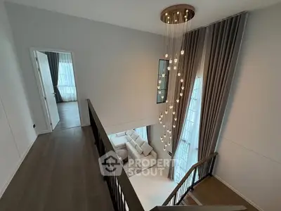 Elegant duplex interior with modern chandelier and spacious living area