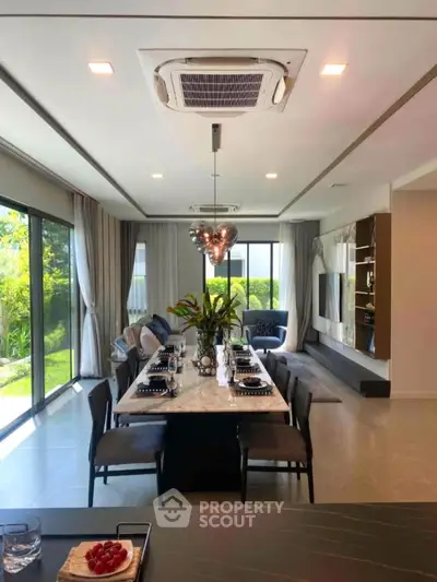 Luxurious modern dining room with elegant decor and large windows overlooking a garden.