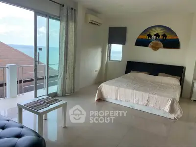 Spacious bedroom with ocean view and modern decor in luxury property