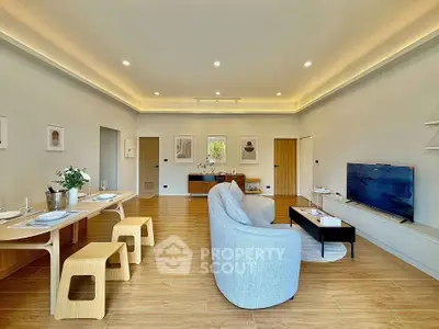 Spacious modern living room with elegant decor and ample natural light.