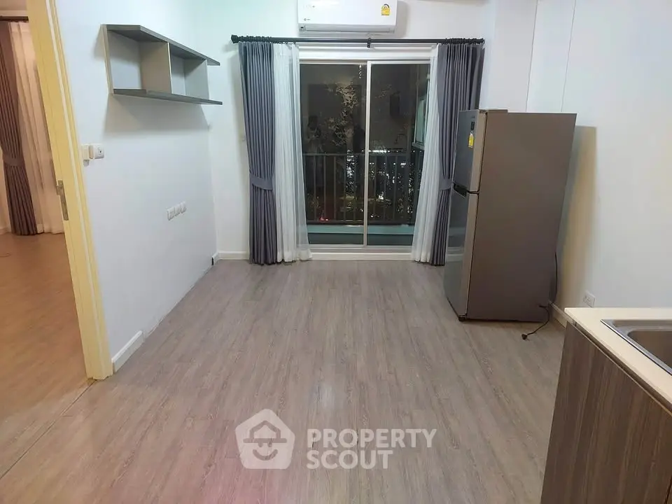 Modern apartment interior with sleek kitchen and balcony view, featuring stylish flooring and contemporary design.