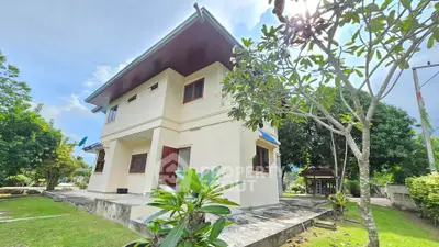 Charming two-story house with lush garden and spacious outdoor area, perfect for family living.