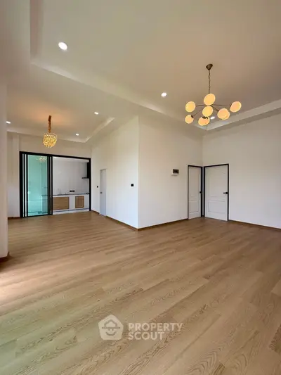 Spacious modern living room with elegant lighting and wooden flooring