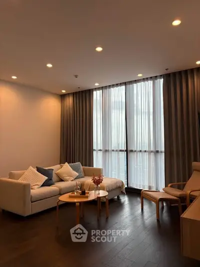 Elegant living room with modern furniture and floor-to-ceiling windows