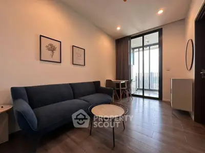 Modern living room with stylish furniture and balcony view in a contemporary apartment.