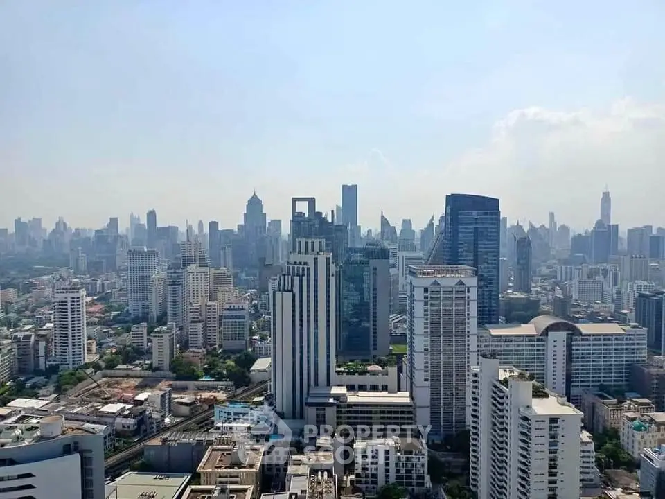 Stunning cityscape view showcasing a vibrant skyline with modern skyscrapers under a clear blue sky.
