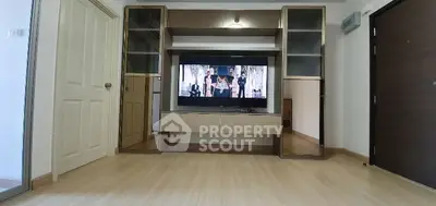 Modern living room with built-in entertainment center and sleek flooring