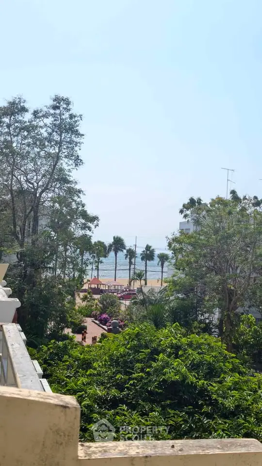 Stunning ocean view from a lush green balcony, perfect for relaxation and enjoying nature.