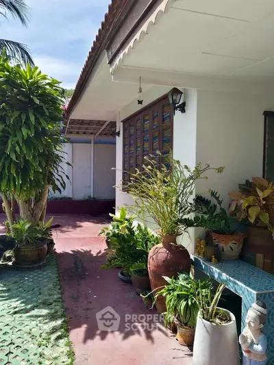 Charming garden entrance with lush greenery and decorative elements