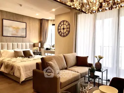 Luxurious open-plan living room and bedroom with elegant decor and large windows.