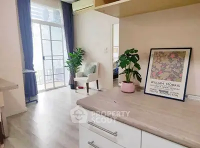 Charming living room with balcony access and stylish decor in modern apartment.