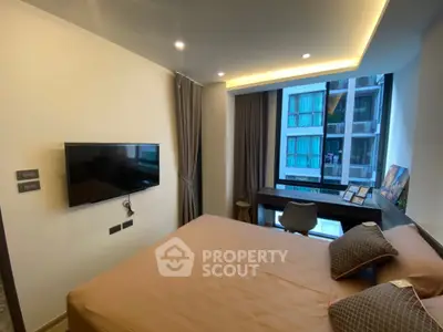 Modern bedroom with large window and wall-mounted TV in stylish apartment