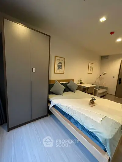 Modern bedroom with sleek wardrobe and cozy bed setup