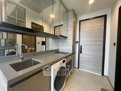 Modern kitchen with sleek design and built-in washing machine