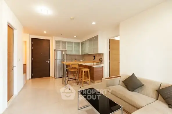 Modern open-plan living room with kitchen and stylish furniture