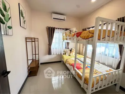 Charming bedroom with bunk beds and natural light, perfect for kids or guests.