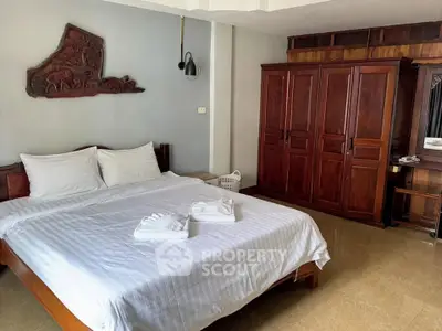 Spacious bedroom with elegant wooden furniture and cozy ambiance