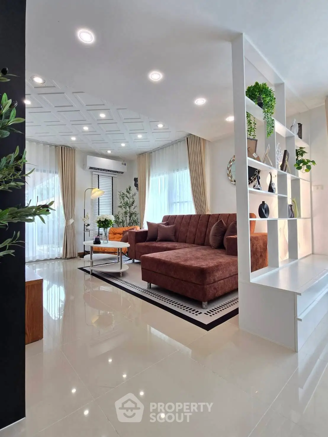 Modern living room with stylish decor and large windows for natural light.