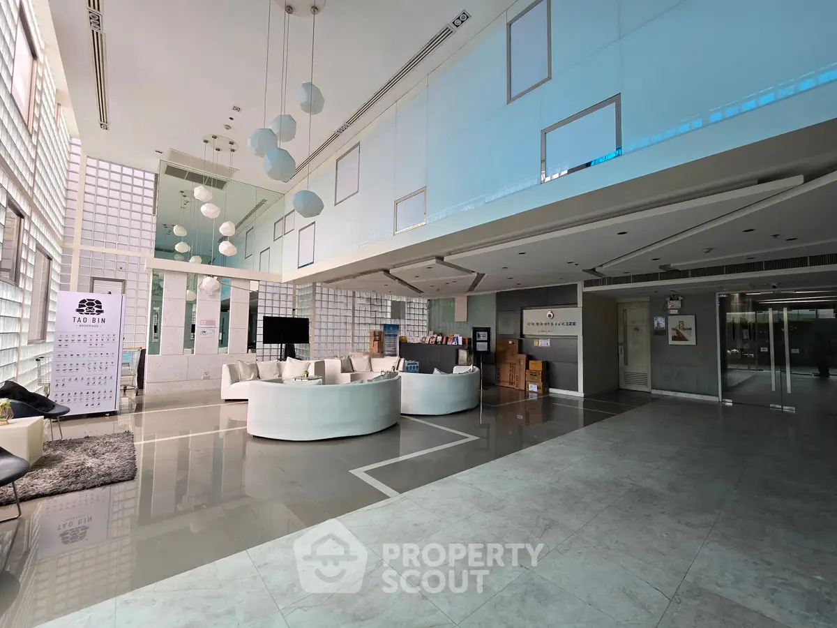 Luxurious modern building entrance with sleek design and stylish seating area