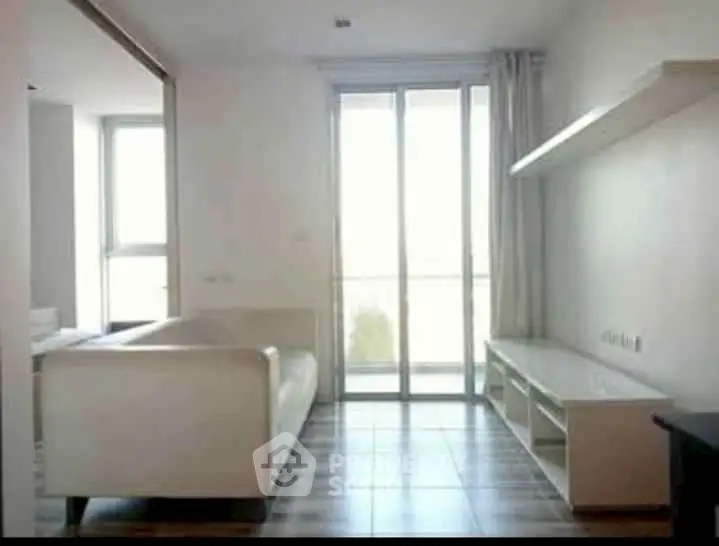 Modern living room with sleek furniture and large windows for natural light.