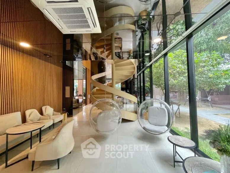 Luxurious modern living room with spiral staircase and hanging chairs, featuring floor-to-ceiling windows and garden view.