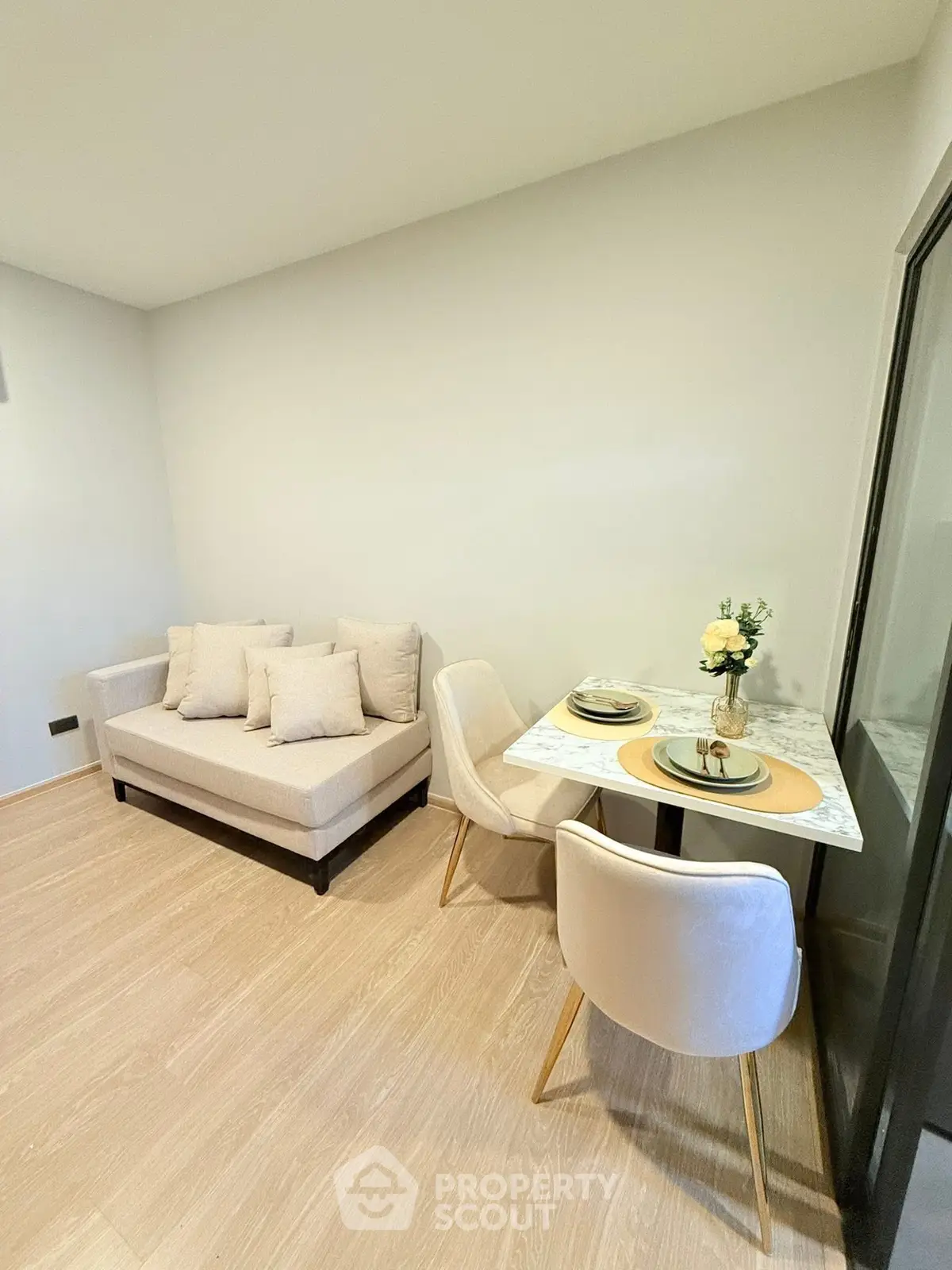 Cozy living room with modern sofa and elegant dining set in a stylish apartment.