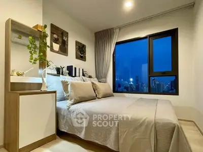 Cozy bedroom with city view, modern decor, and ample natural light.