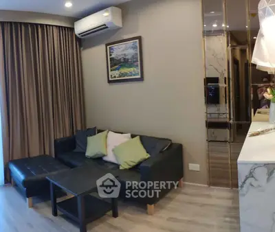 Modern living room with black leather sofa and air conditioning