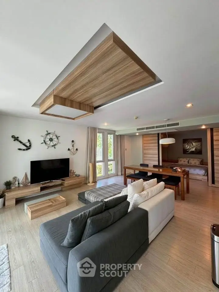 Spacious modern living room with stylish decor and open layout, featuring a cozy seating area and dining space.