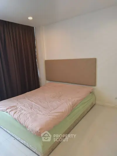 Cozy bedroom with soft lighting and elegant curtains, perfect for relaxation.