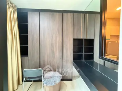 Modern study room with sleek wooden cabinetry and large window