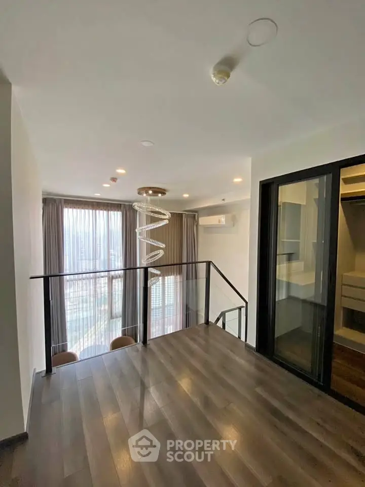Modern duplex apartment with floor-to-ceiling windows and stylish spiral staircase