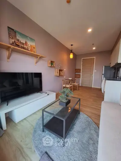 Modern living room with stylish decor and open layout, featuring a cozy seating area and contemporary furnishings.