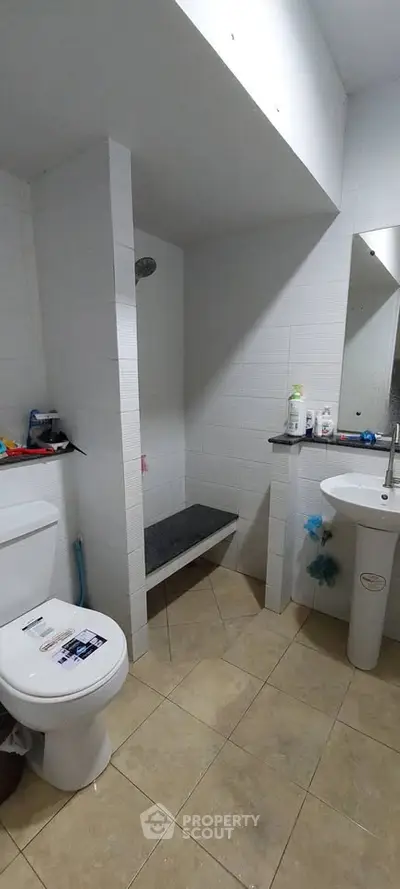 Modern bathroom with shower and sleek fixtures in a contemporary home.
