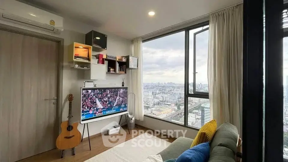 Modern living room with large window offering stunning city view, stylish decor, and cozy seating area.