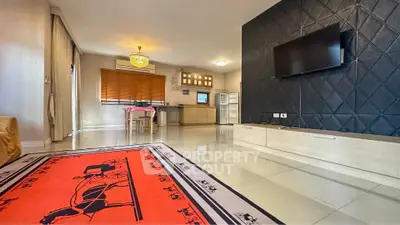 Spacious modern living room with stylish decor and open kitchen layout, perfect for entertaining.