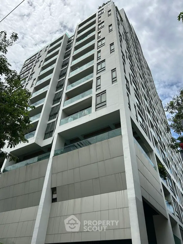 Modern high-rise building with sleek architecture and spacious balconies.