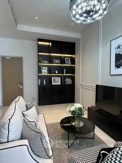 Elegant living room with modern decor, stylish shelving, and cozy seating area.