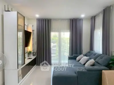 Modern living room with sleek furniture and large windows for natural light