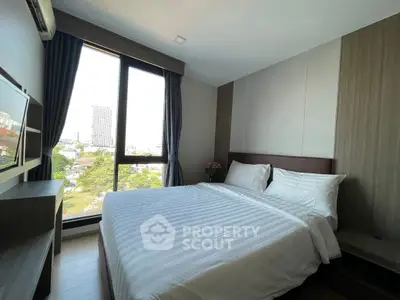 Modern bedroom with large window and city view, featuring a comfortable bed and stylish decor.