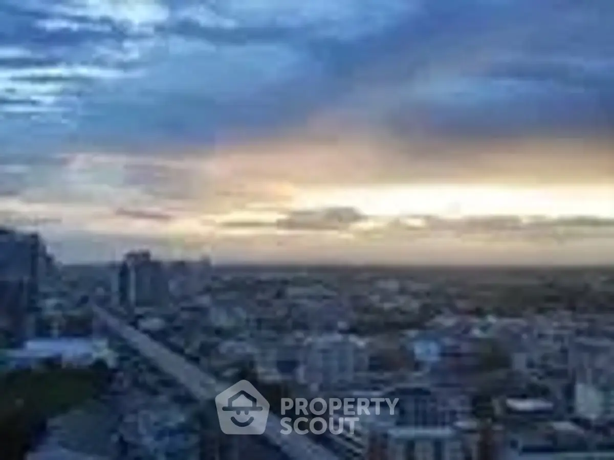 Stunning cityscape view from a high-rise building at sunset, showcasing urban skyline.