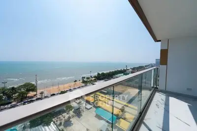 Stunning beachfront balcony with panoramic ocean views and modern glass railing.