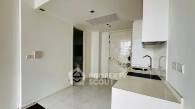 Modern minimalist kitchen with sleek white cabinetry and compact design