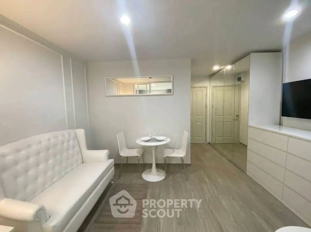 Modern living room with elegant white furniture and sleek design