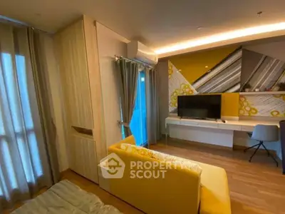 Modern living room with stylish decor and cozy ambiance, featuring a yellow sofa and wall-mounted TV.