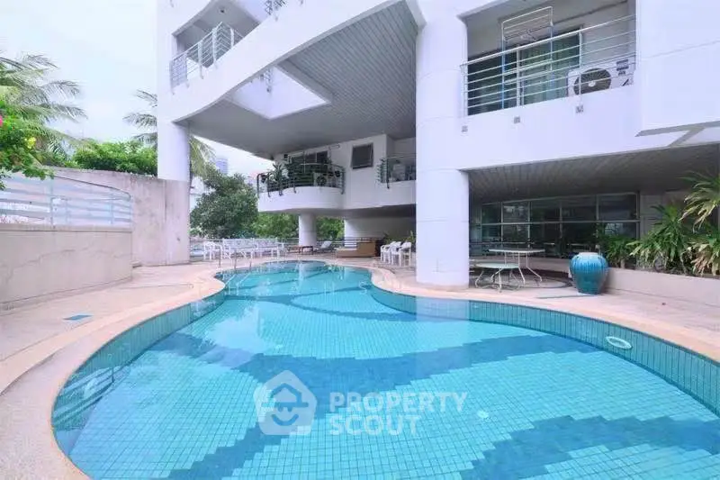 Luxurious residential building with a stunning outdoor pool and modern architecture.