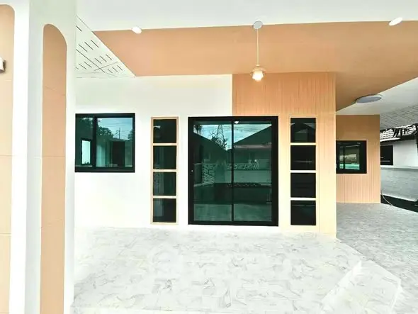 Modern exterior view of a stylish home with large windows and sleek design.