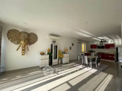 Spacious open-plan living room with modern kitchen and elegant decor