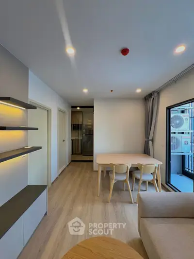 Modern living room with dining area and balcony access in stylish apartment